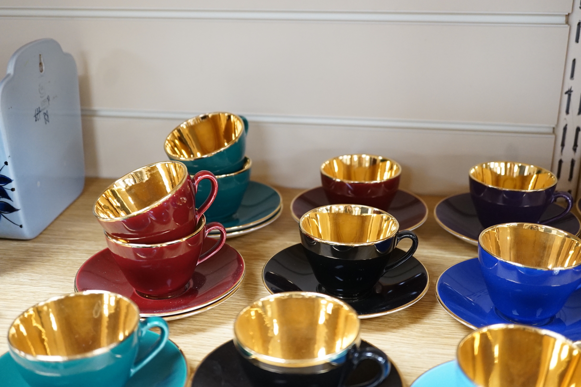 Fourteen Copenhagen Alumina, ‘Confetti’ patterned coffee cups and saucers in varying colours with gilt interiors